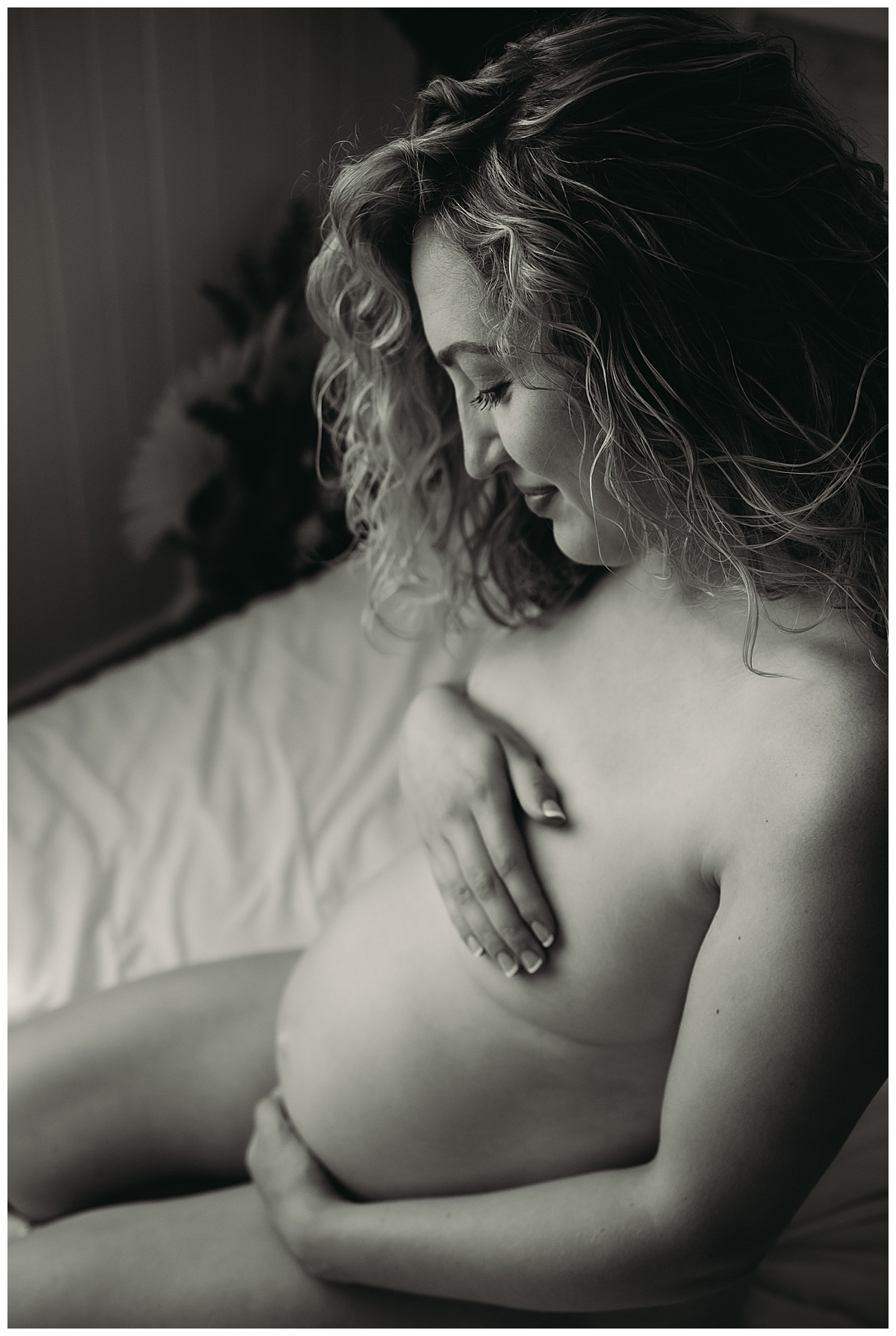 Woman hugs belly for Minneapolis Boudoir Photographer