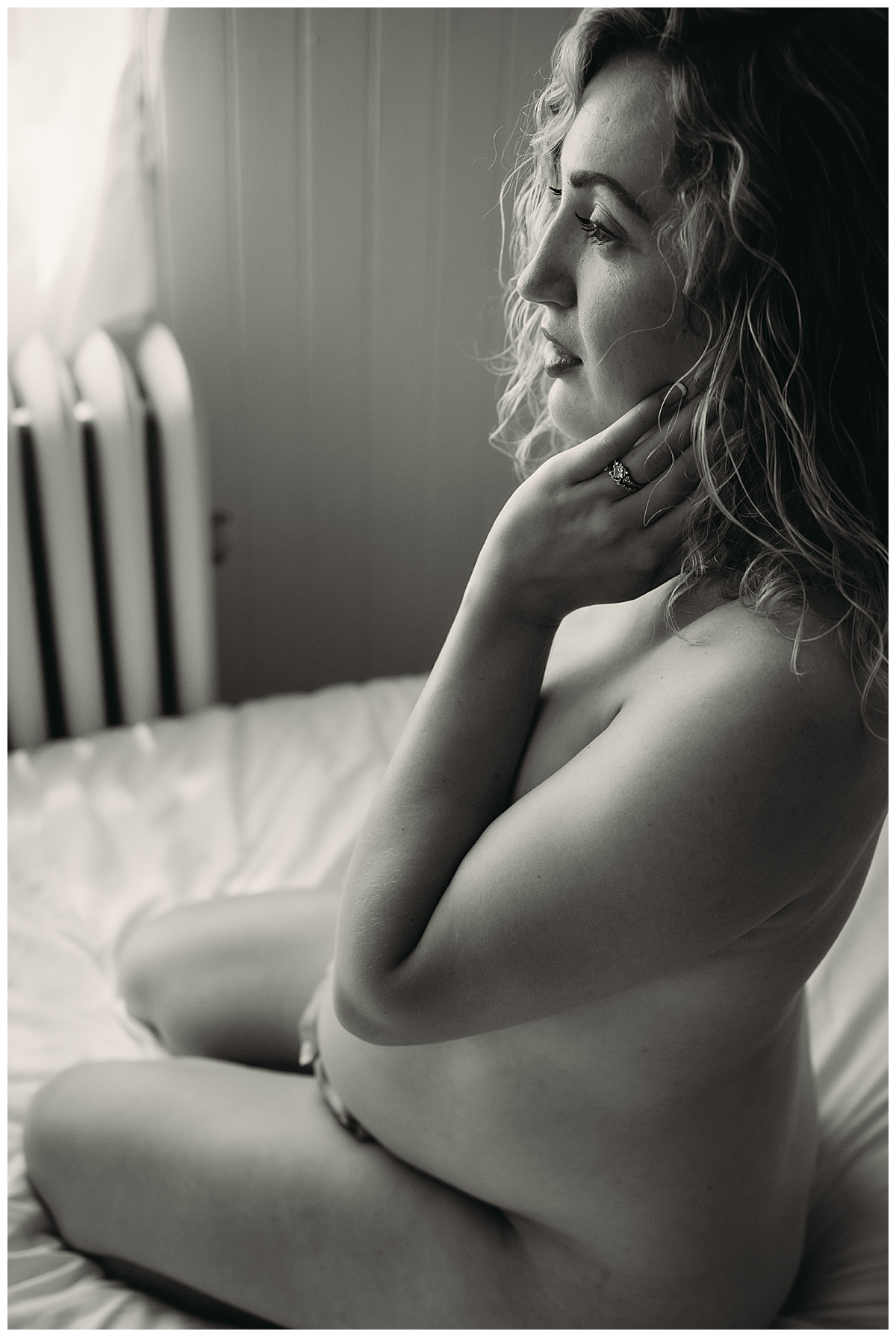 Mama to be holds hand to face by Boudoir Photography Minnesota