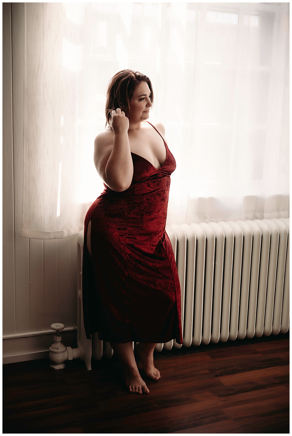 Woman stands by window for Boudoir Photography Minnesota