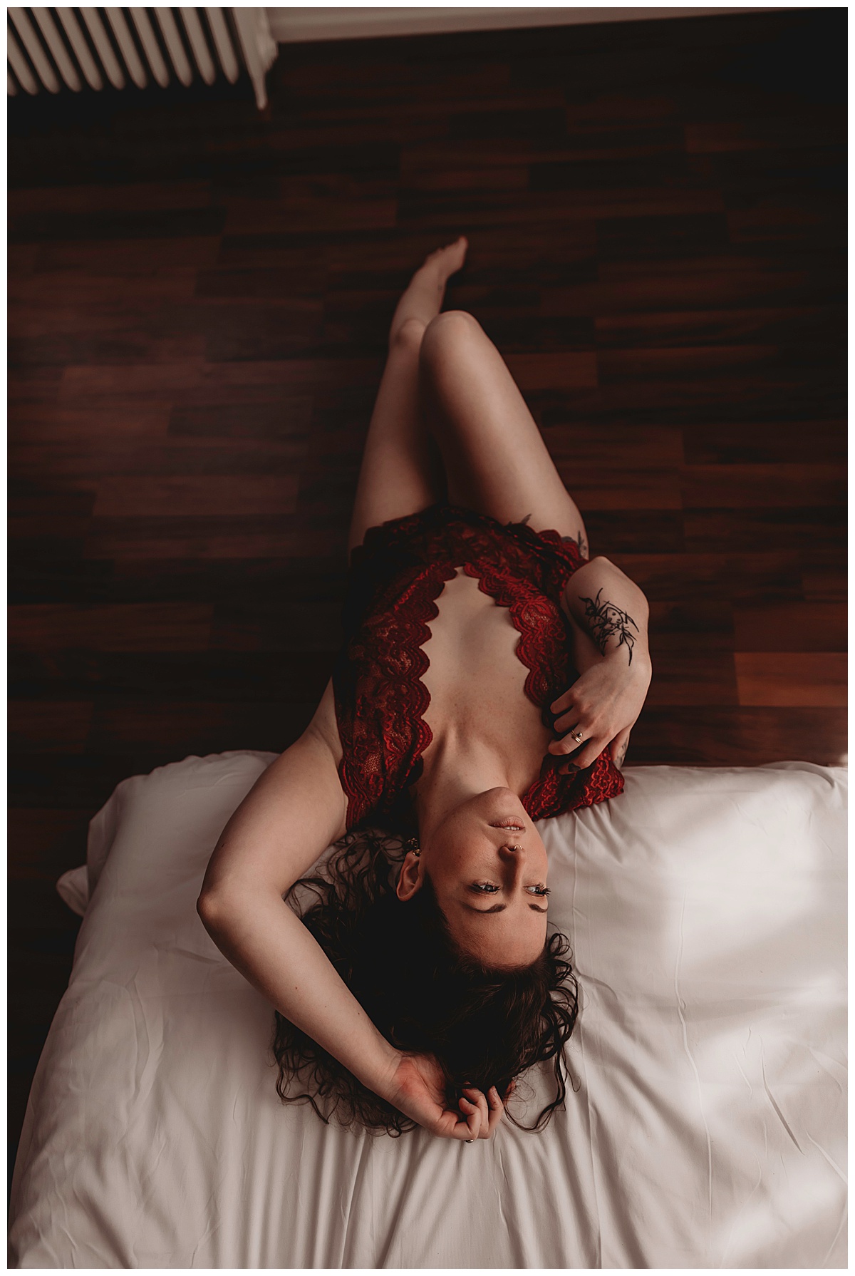 Adult lays on edge of bed for Boudoir Photography Minnesota