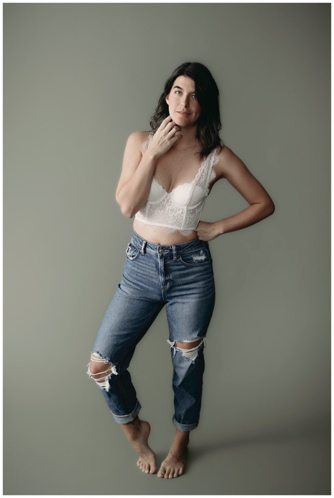 Woman stands in jeans and bralette for Minneapolis Boudoir Photographer