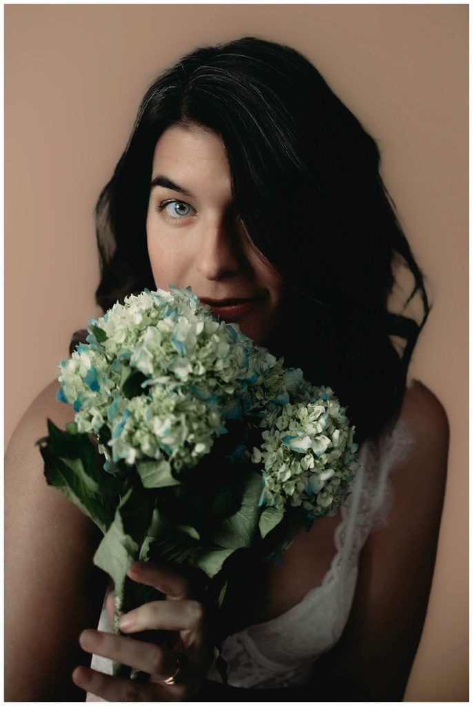 Floral bouquet near woman's face for Minneapolis Boudoir Photographer