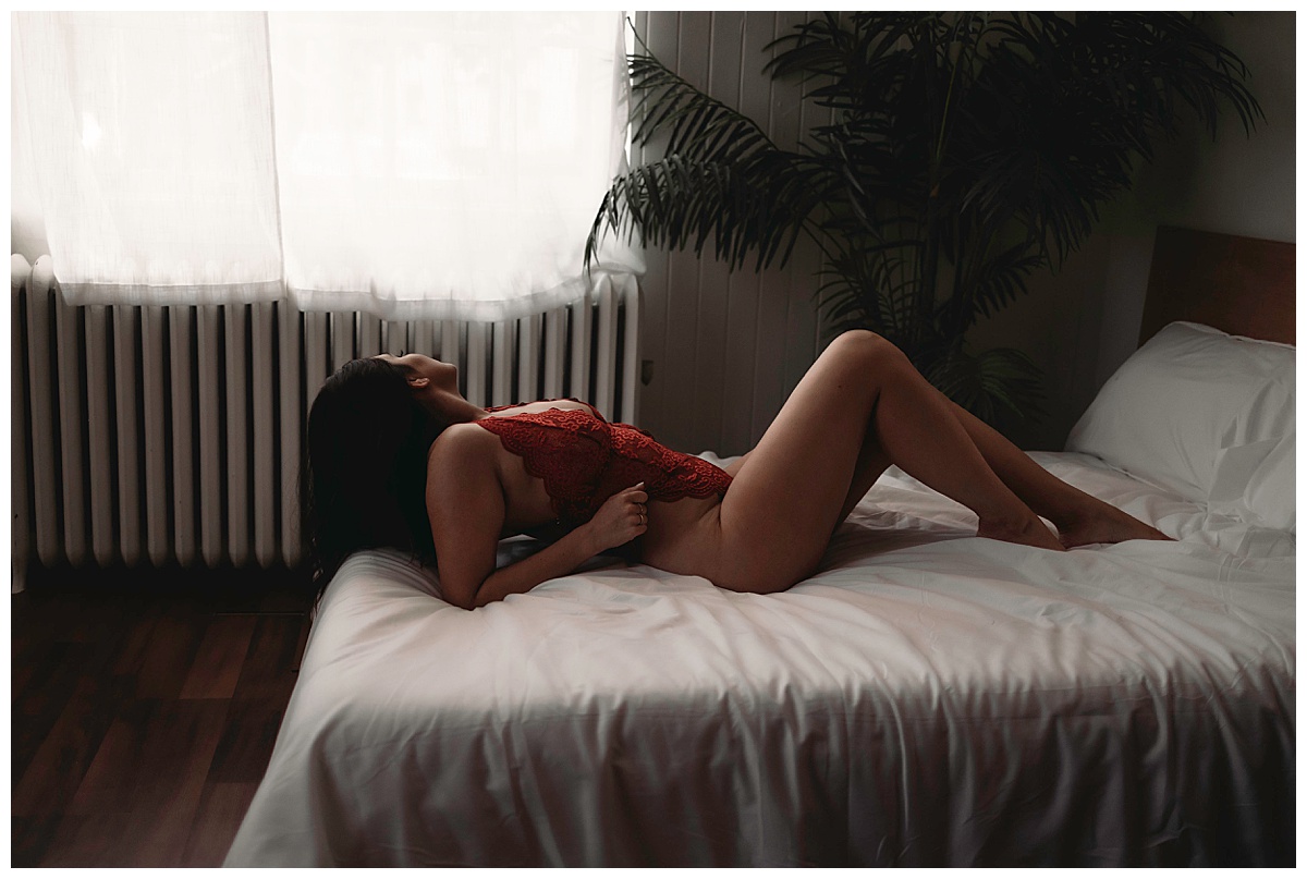 Female lays on bed for Boudoir Photography Minnesota