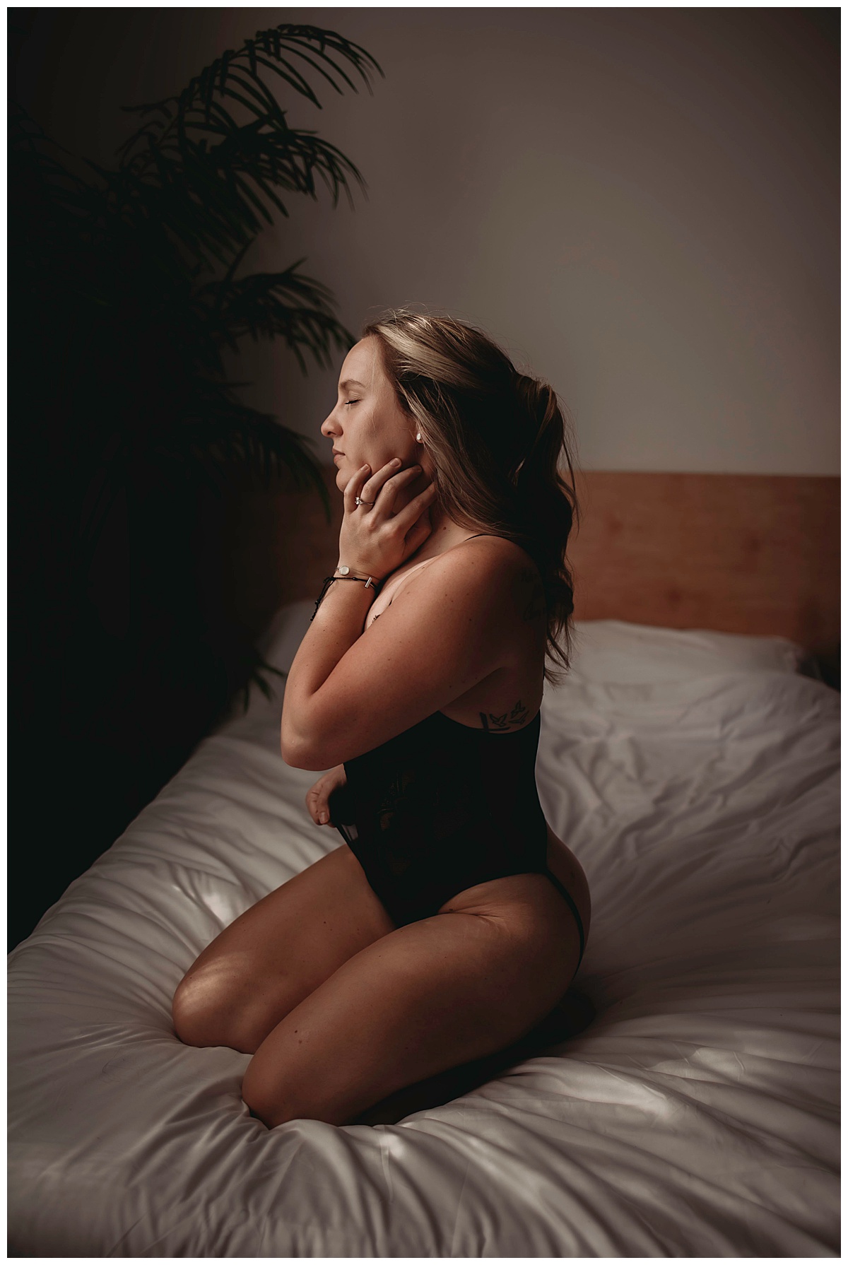Female kneels on bed for Minneapolis Boudoir Photographer