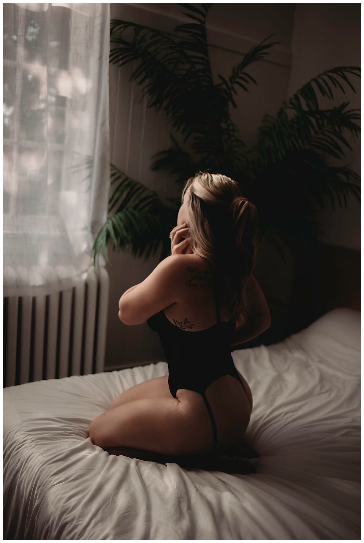Blond lady kneels on bed for Boudoir Photography Minnesota