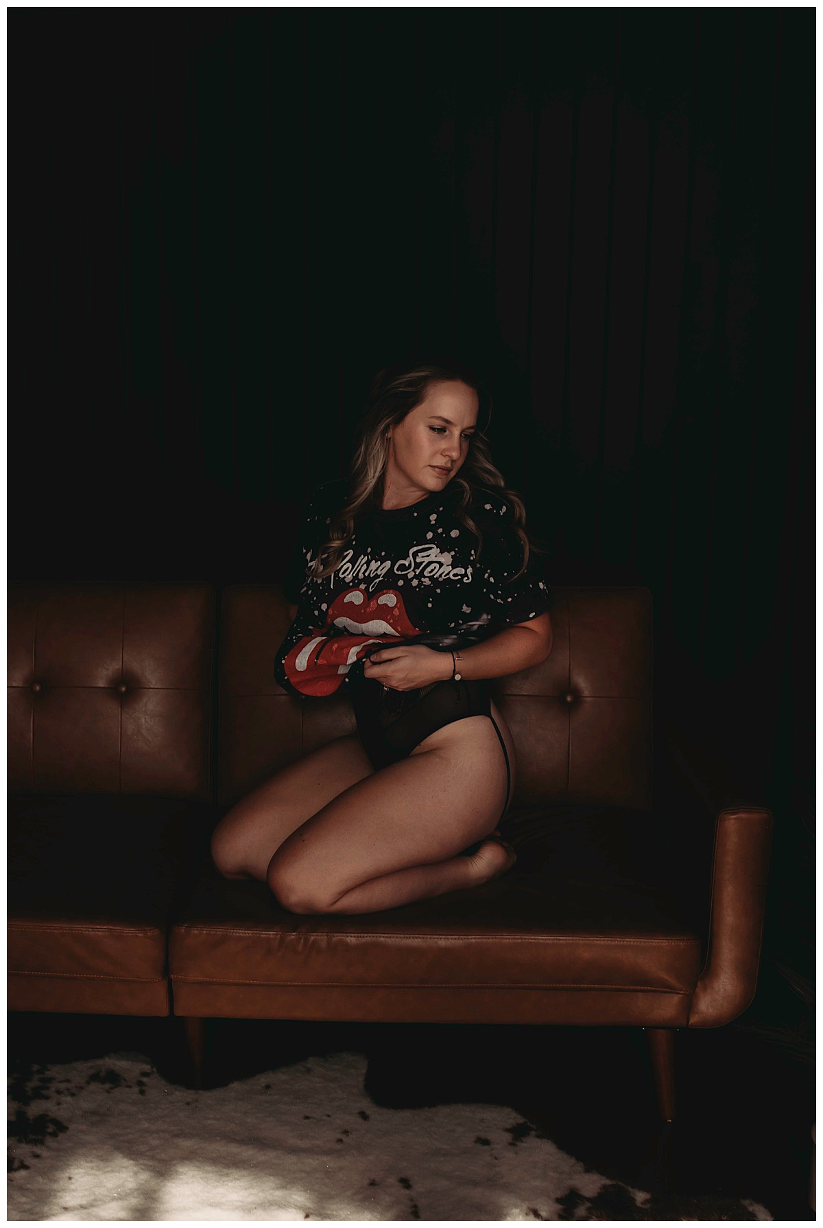Woman in Simple And Sexy band tshirt on couch 
