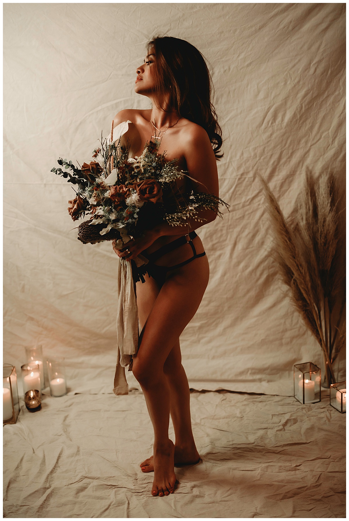 Adult covers up with flowers for Minneapolis Boudoir Photographer